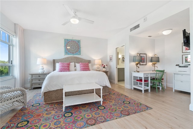 bedroom featuring connected bathroom, light hardwood / wood-style floors, and ceiling fan