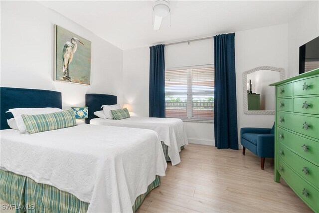 bedroom with light hardwood / wood-style floors and ceiling fan