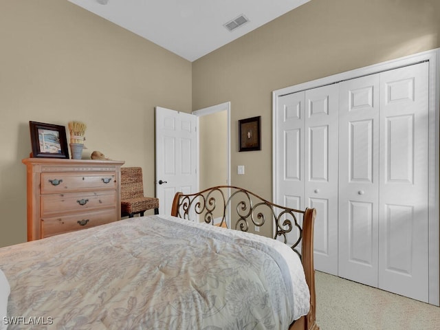 bedroom with a closet and light colored carpet