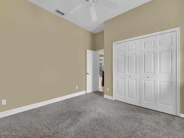 unfurnished bedroom with ceiling fan, a closet, and carpet flooring