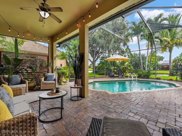 view of swimming pool featuring a patio, a lanai, and ceiling fan