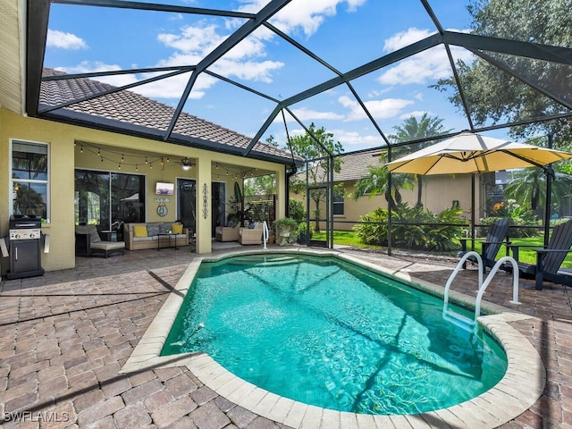 view of swimming pool featuring outdoor lounge area, a lanai, ceiling fan, and a patio area