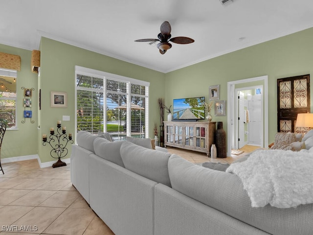 tiled living room featuring ceiling fan and crown molding