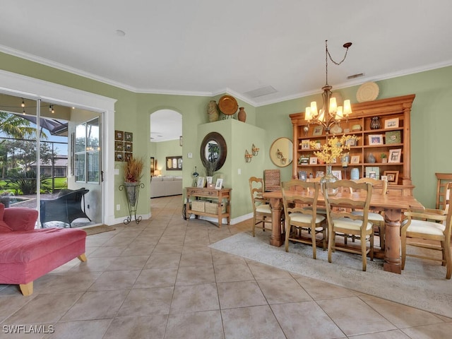 dining area with light tile patterned flooring, a chandelier, and ornamental molding