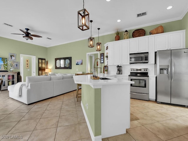 kitchen with white cabinets, decorative light fixtures, stainless steel appliances, a breakfast bar, and ceiling fan with notable chandelier