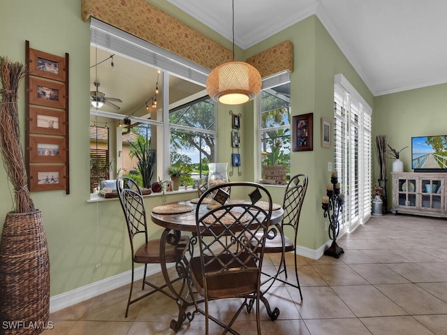 dining area with ceiling fan, crown molding, and tile patterned flooring