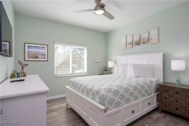 bedroom featuring dark hardwood / wood-style floors and ceiling fan