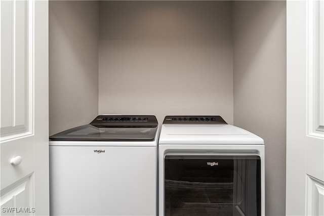 clothes washing area featuring separate washer and dryer