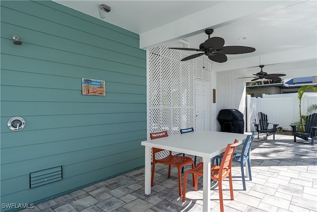 view of patio with area for grilling and ceiling fan