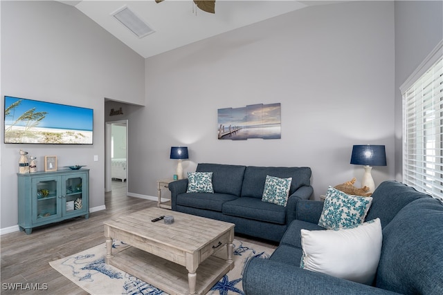 living room featuring high vaulted ceiling, light hardwood / wood-style floors, and ceiling fan