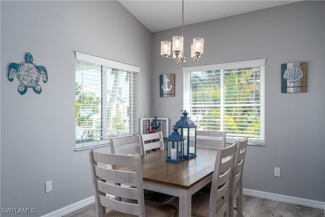 dining room with an inviting chandelier, hardwood / wood-style flooring, and a healthy amount of sunlight