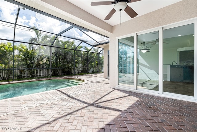 view of swimming pool featuring a patio area, ceiling fan, and a lanai