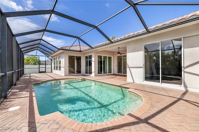 view of pool featuring ceiling fan, a patio area, and glass enclosure