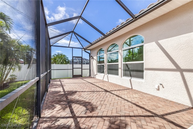 unfurnished sunroom featuring vaulted ceiling