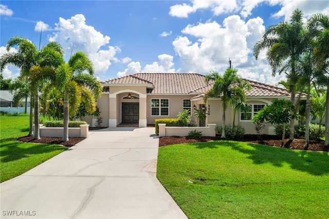 mediterranean / spanish home with a front lawn