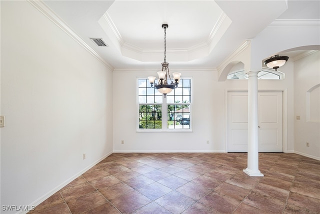 spare room with ornamental molding, ornate columns, an inviting chandelier, and a tray ceiling