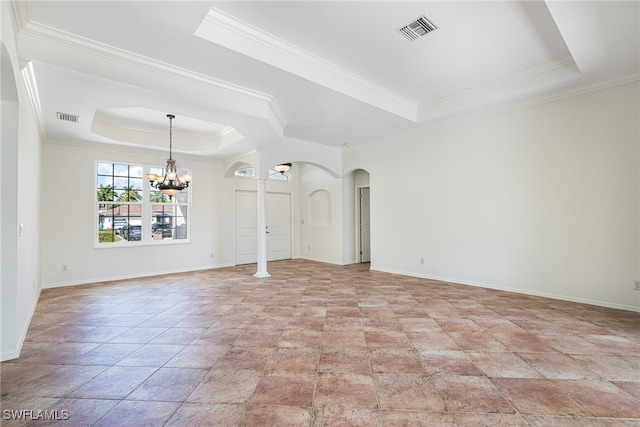 unfurnished room with ornamental molding, a raised ceiling, a notable chandelier, and decorative columns