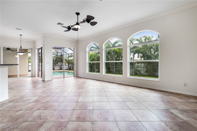 unfurnished living room featuring plenty of natural light, ceiling fan, and ornamental molding