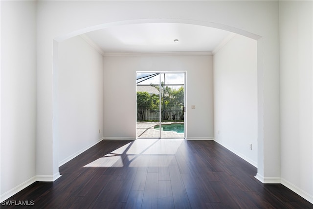 spare room with crown molding and dark hardwood / wood-style flooring