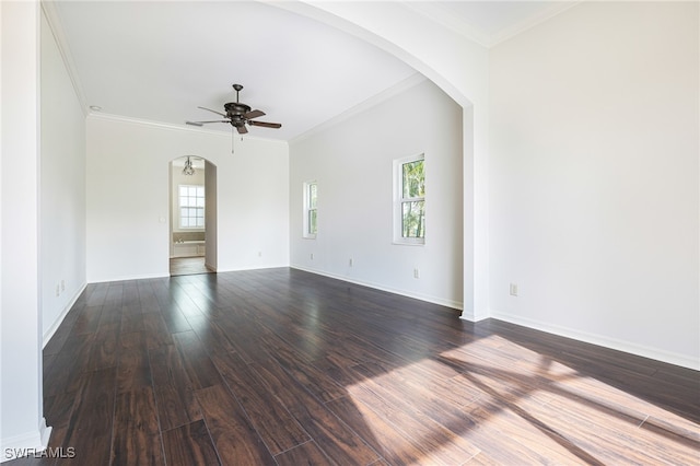 empty room featuring ornamental molding, dark wood-type flooring, and ceiling fan