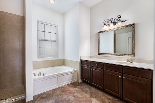 bathroom featuring vanity and separate shower and tub