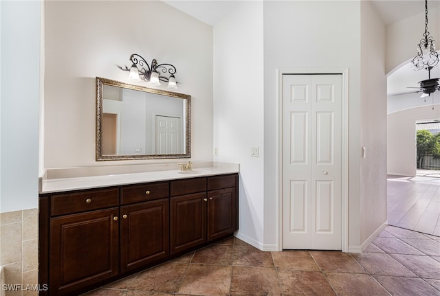 bathroom featuring vaulted ceiling, ceiling fan, hardwood / wood-style flooring, and vanity