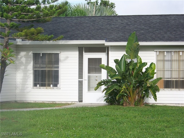 doorway to property featuring a yard