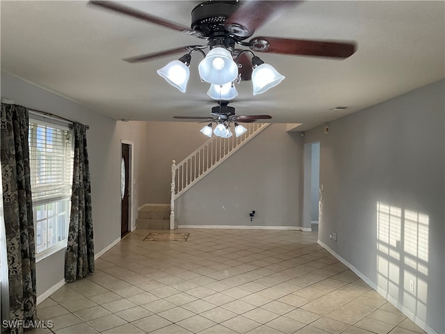 spare room featuring light tile patterned floors and ceiling fan