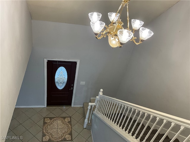 tiled foyer with an inviting chandelier