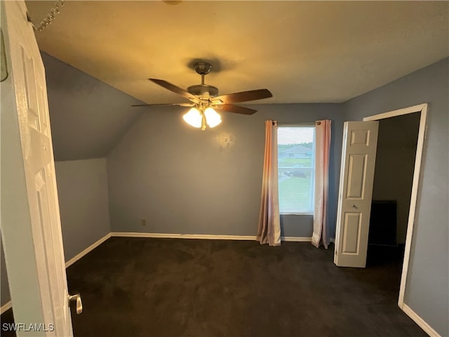 bonus room featuring lofted ceiling, dark colored carpet, and ceiling fan