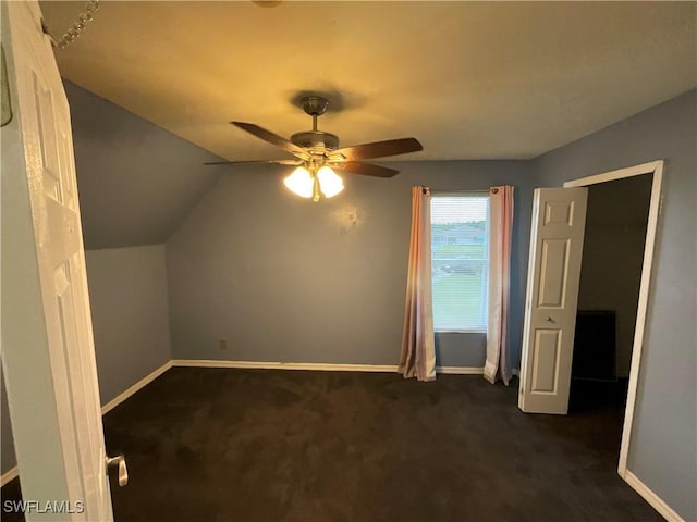 804 Yvonne Ave N, Lehigh Acres, FL 33971 - additional living space with dark carpet, baseboards, a ceiling fan, and lofted ceiling