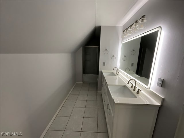 bathroom with vanity, vaulted ceiling, tile patterned floors, and plus walk in shower