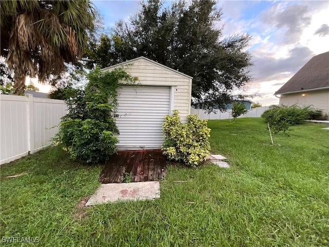 view of yard featuring an outbuilding and a garage