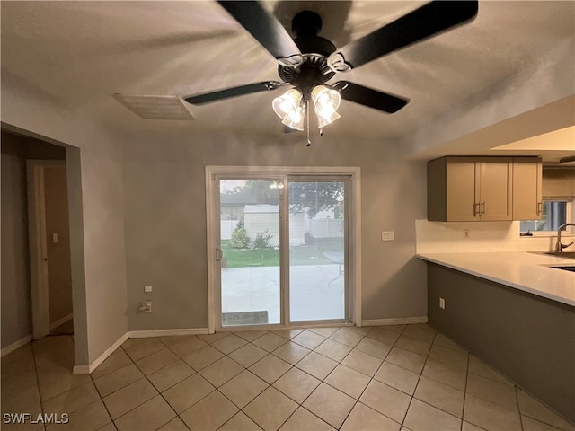 interior space featuring sink, light tile patterned floors, and ceiling fan