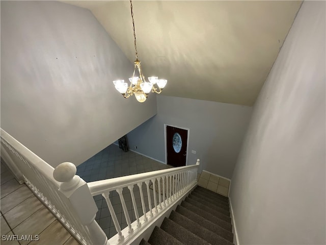 stairs featuring lofted ceiling and a notable chandelier