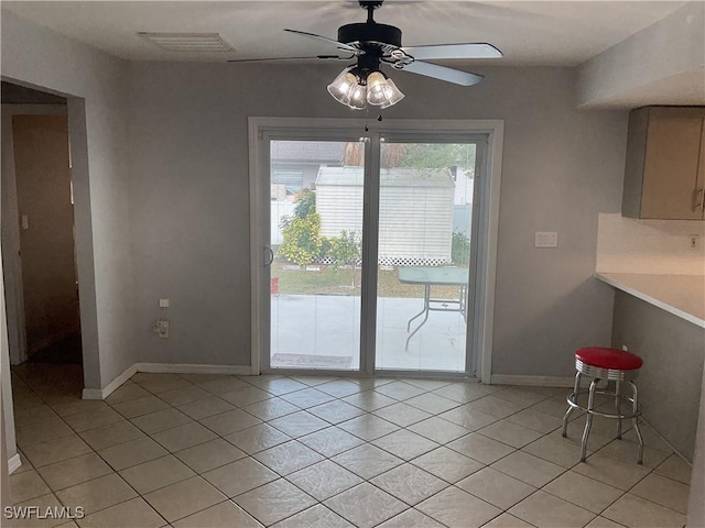 804 Yvonne Ave N, Lehigh Acres, FL 33971 - unfurnished dining area featuring light tile patterned floors, a ceiling fan, and baseboards