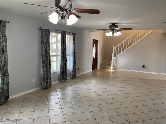 804 Yvonne Ave N, Lehigh Acres, FL 33971 - empty room featuring light tile patterned floors, stairs, and a ceiling fan
