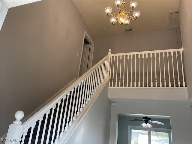 804 Yvonne Ave N, Lehigh Acres, FL 33971 - staircase featuring ceiling fan and a chandelier