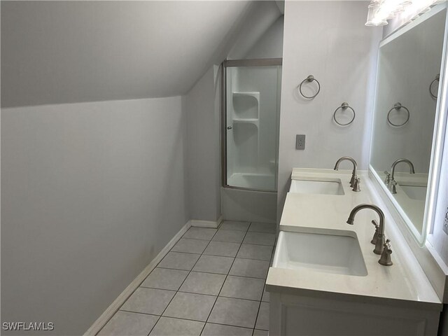 804 Yvonne Ave N, Lehigh Acres, FL 33971 - full bath with tile patterned floors, double vanity,  shower combination, baseboards, and lofted ceiling