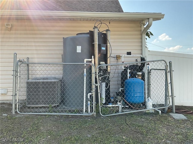 804 Yvonne Ave N, Lehigh Acres, FL 33971 - exterior view of a gate, fence, and a water pressure tank