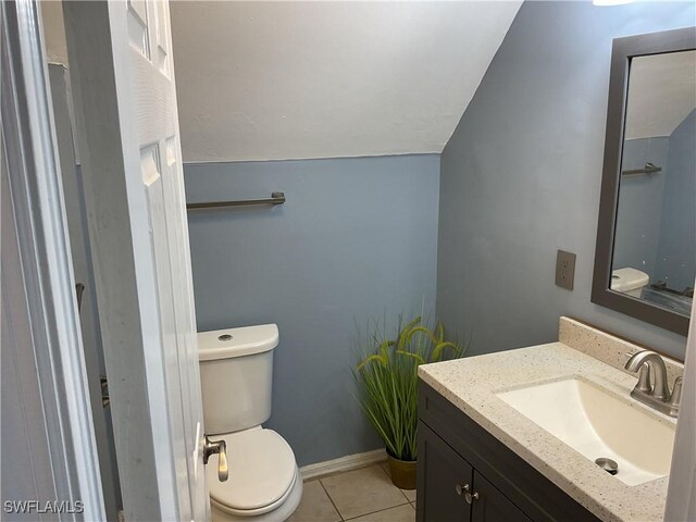804 Yvonne Ave N, Lehigh Acres, FL 33971 - half bath featuring toilet, tile patterned floors, vanity, and lofted ceiling