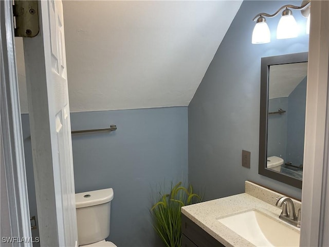 804 Yvonne Ave N, Lehigh Acres, FL 33971 - bathroom with lofted ceiling, toilet, and vanity