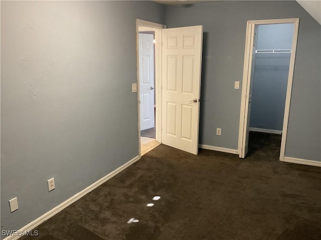804 Yvonne Ave N, Lehigh Acres, FL 33971 - unfurnished bedroom featuring a spacious closet, carpet floors, baseboards, and a closet