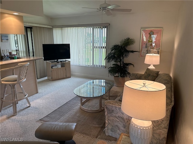 living room featuring carpet and ceiling fan