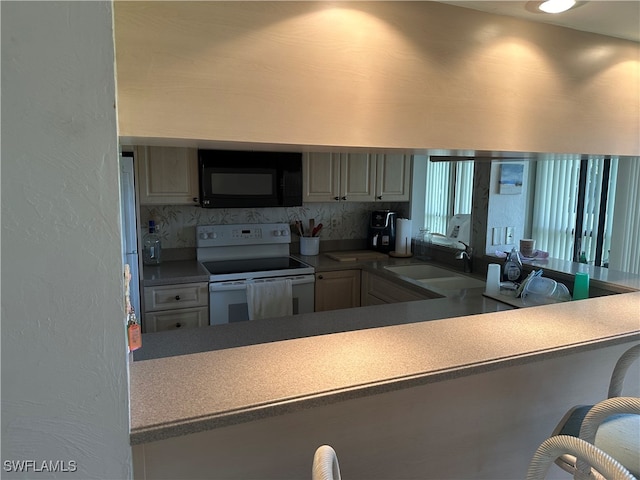 kitchen with electric range, sink, gray cabinets, and tasteful backsplash