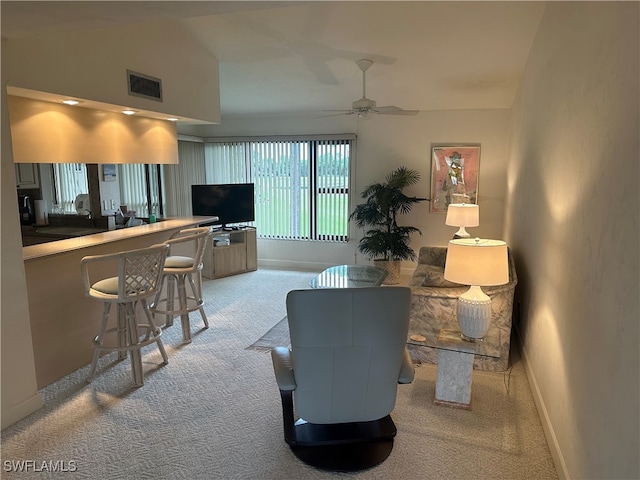 carpeted living room featuring vaulted ceiling and ceiling fan