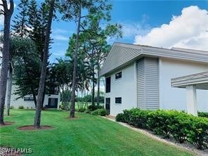 view of side of home featuring a yard