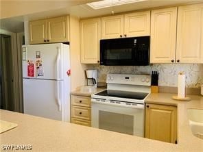 kitchen with white appliances and light brown cabinetry