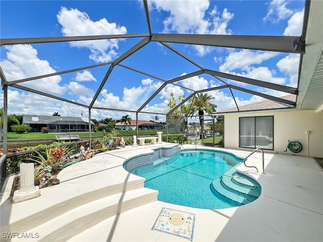 view of swimming pool featuring a patio area and a lanai