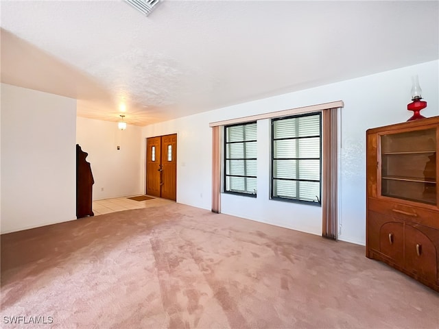 unfurnished living room with light carpet